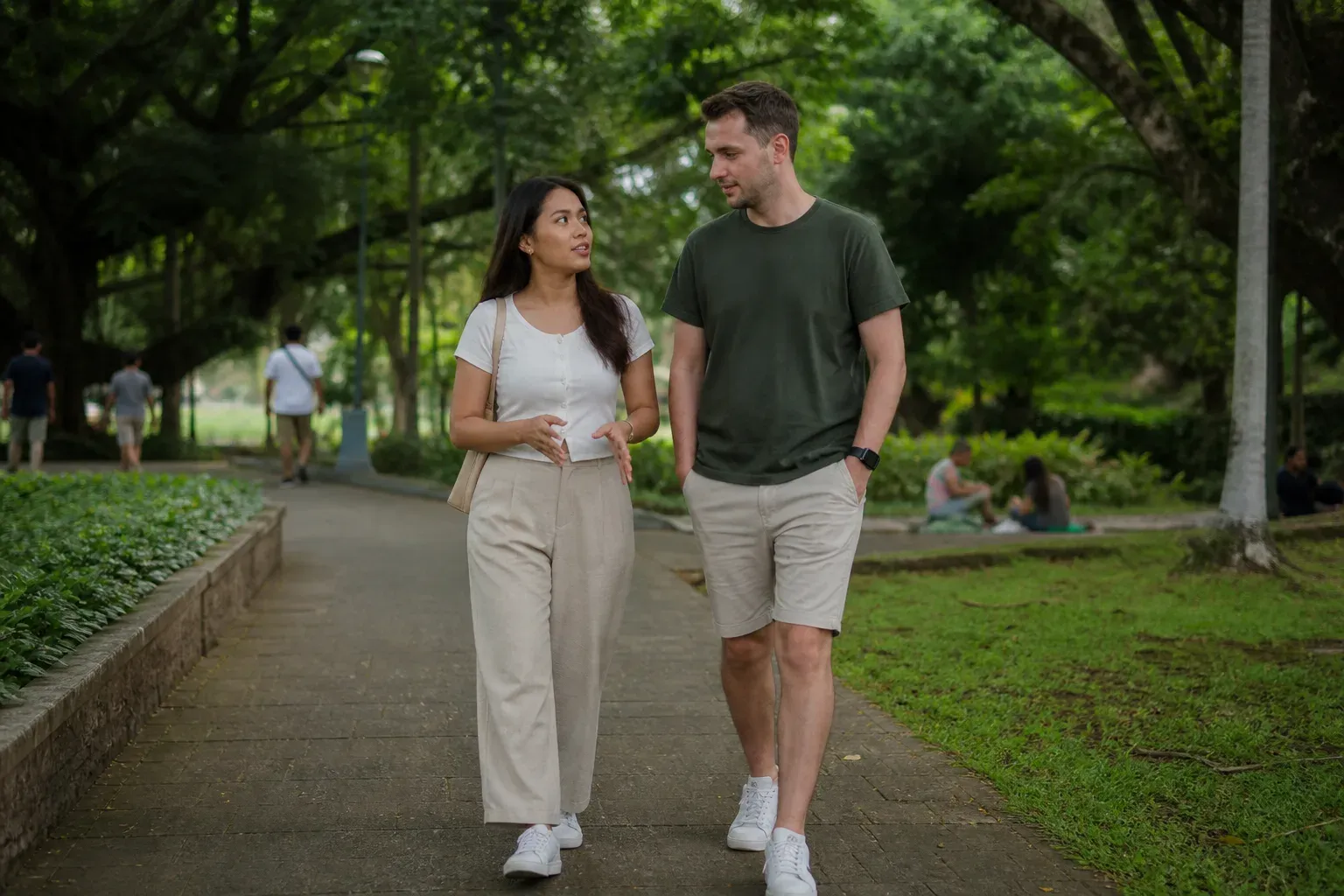 A Filipina and her partner sharing an easy conversation beside Manila Bay